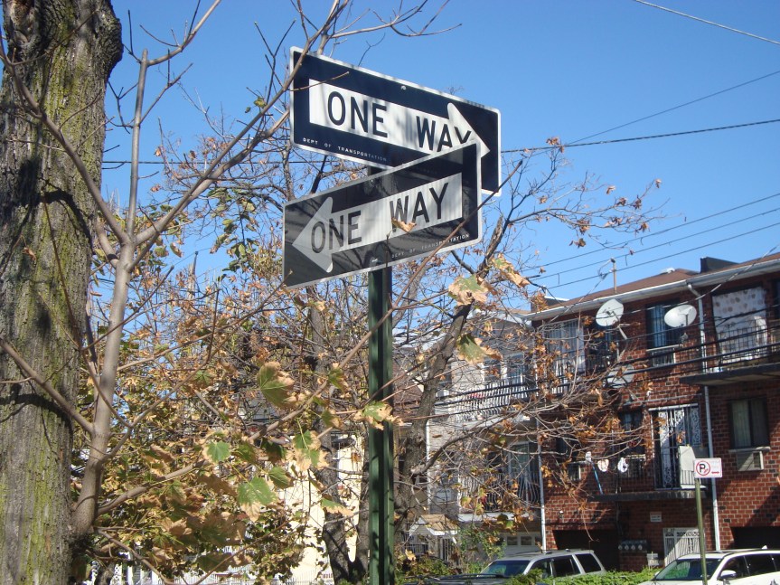 one way street signs on street corner