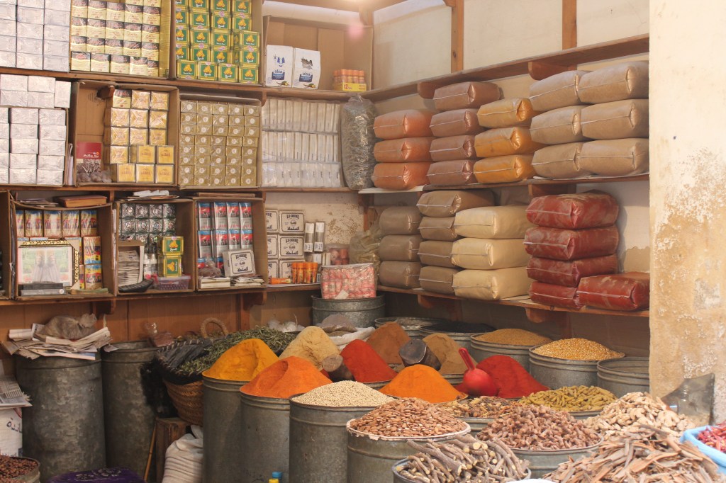 colorful spices heaped in metal bins