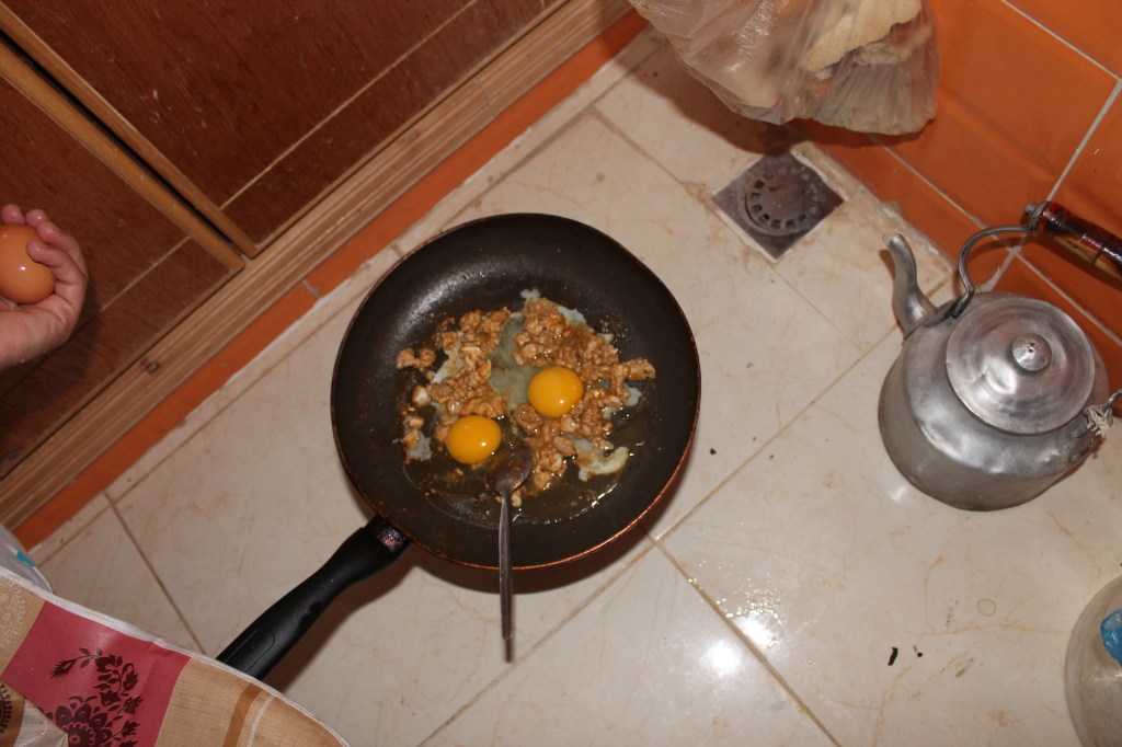 chopped brain and eggs in frying pan