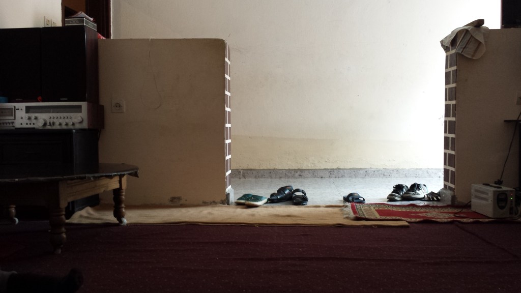 shoes next to carpet in light coming from doorway