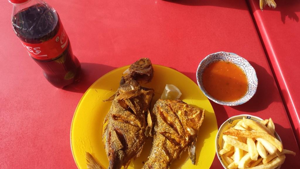 fried fish and french fries with coke on restaurant table