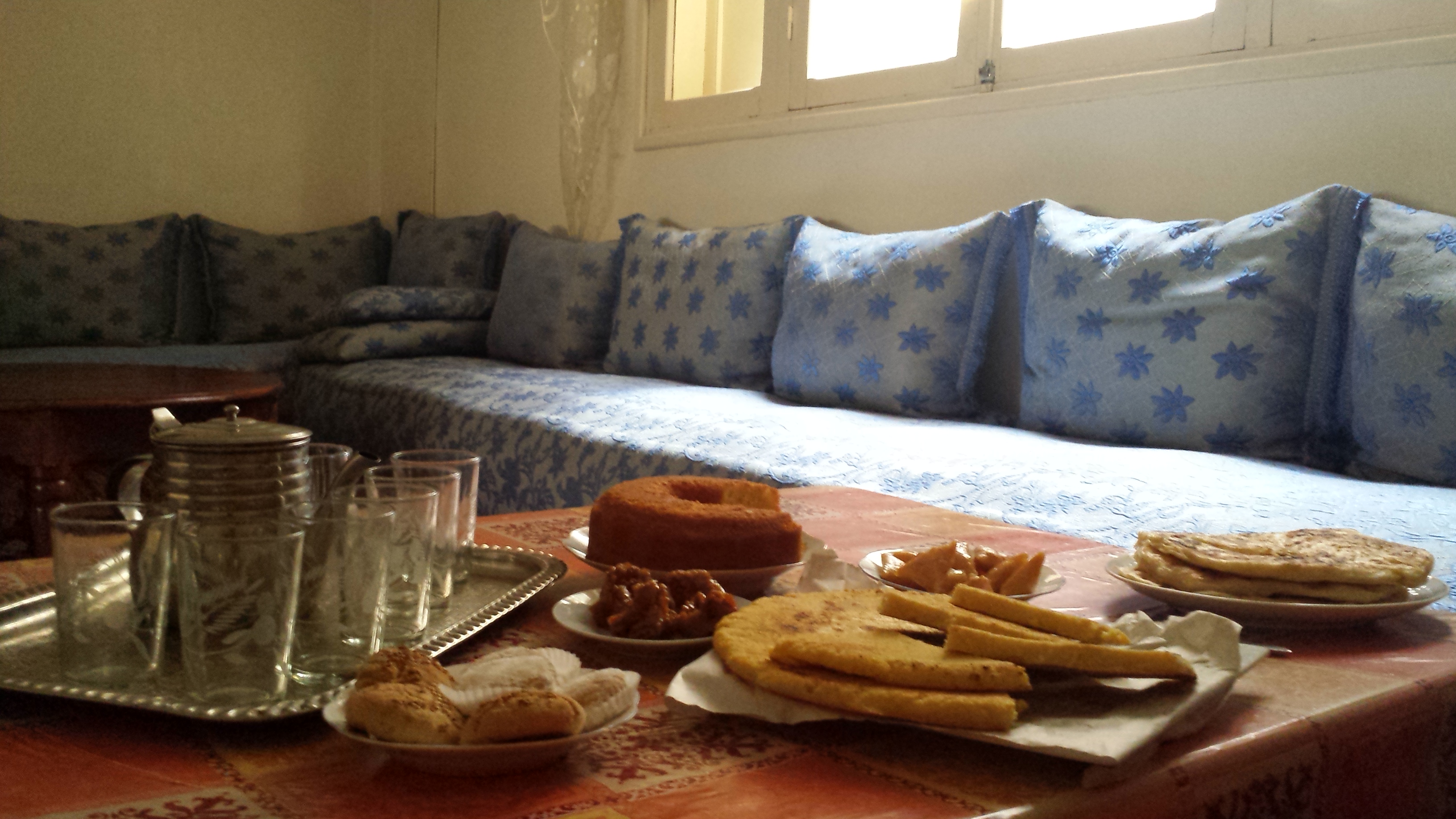 tea and afternoon snack on table in front of north african couches