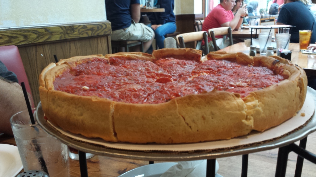 deep dish pizza on restaurant table