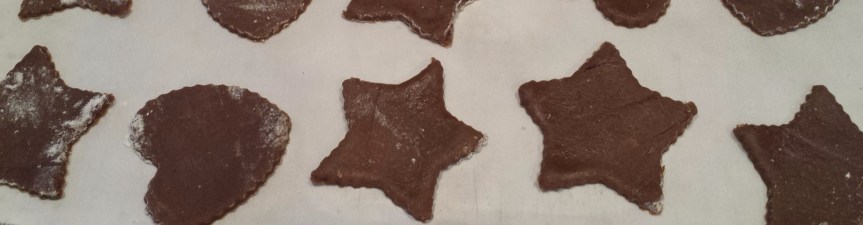 unbaked gingerbread cookies on parchment paper