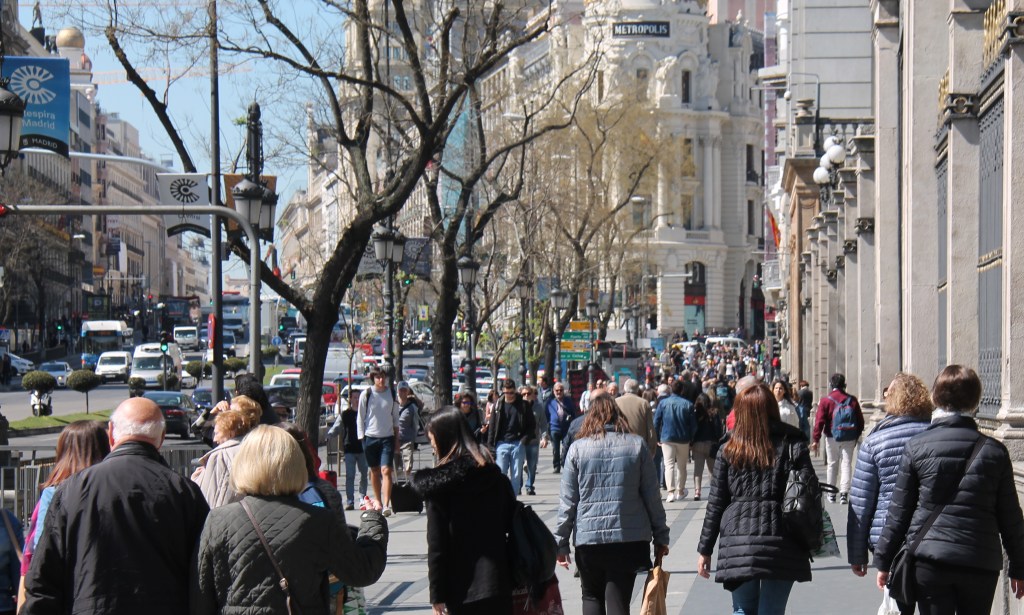 crowds of people walking on busy madrid street