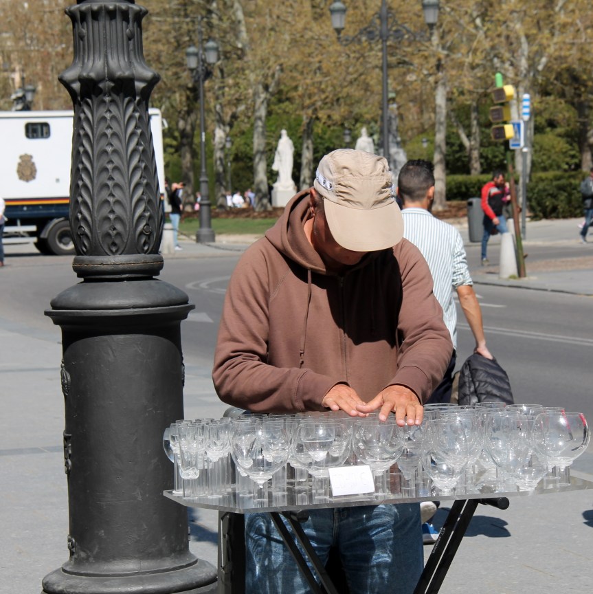 man in brown sweatshirt playing tray of goblets