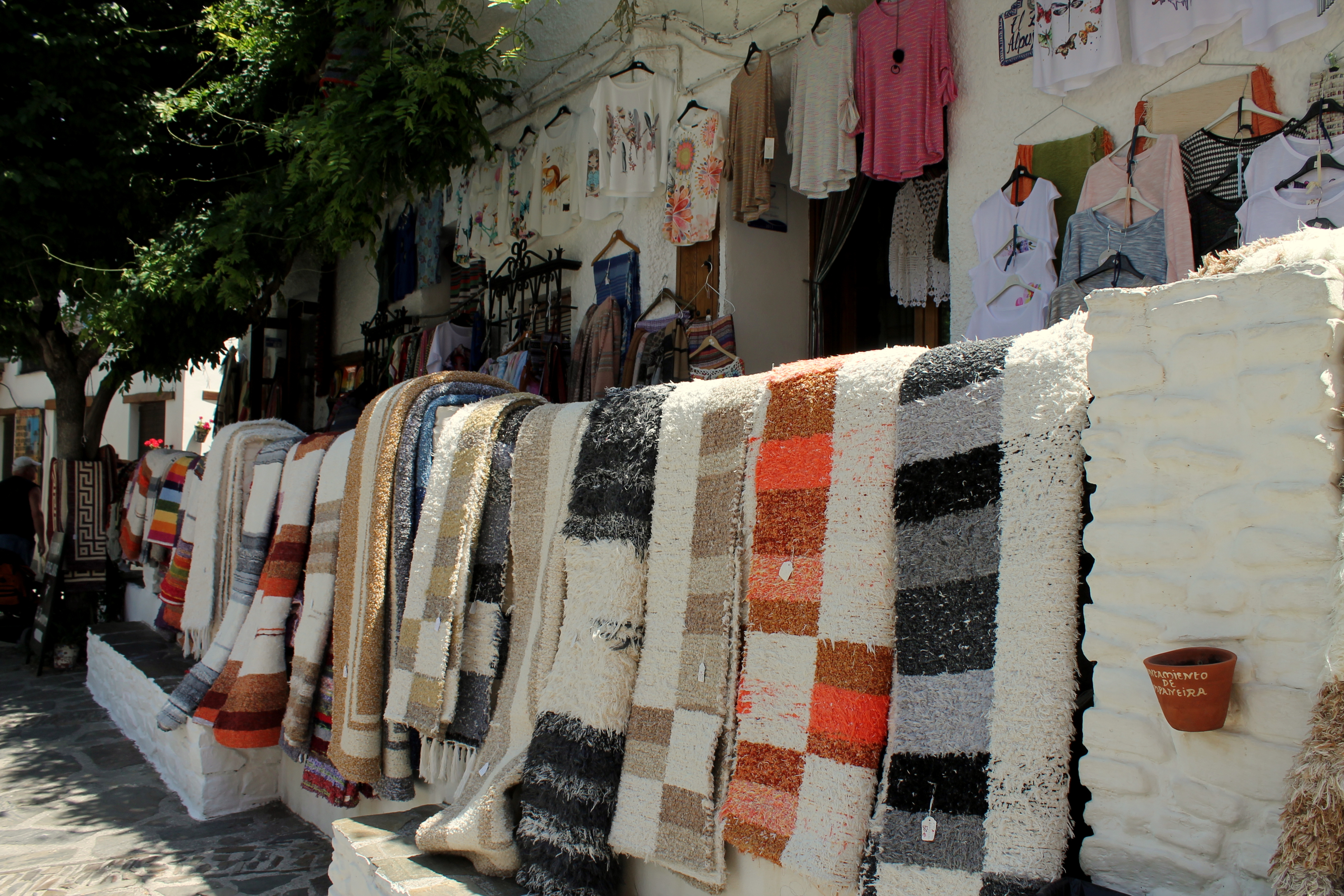 colorful jarapes for sale on stone wall