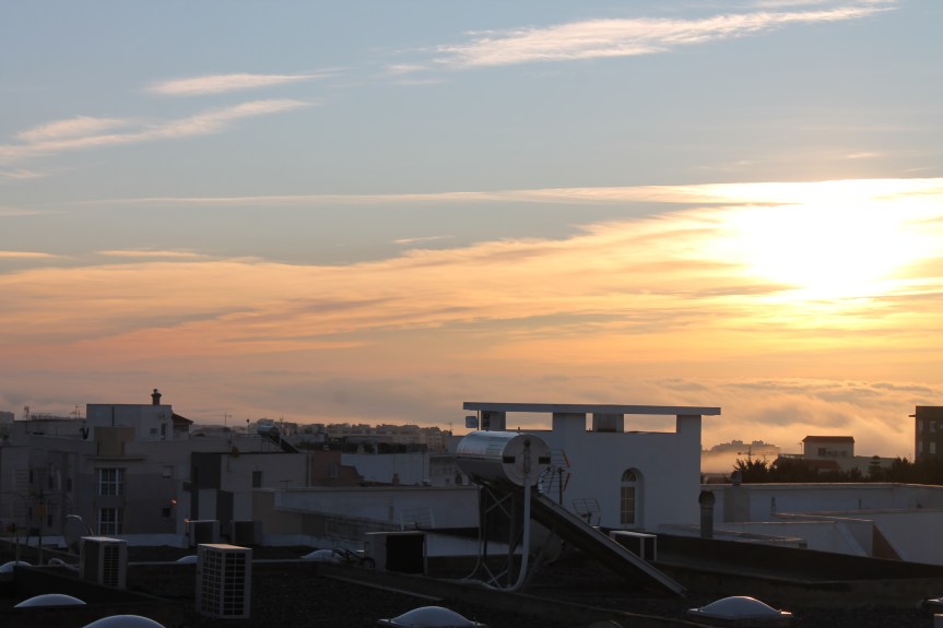sunrise over town and fog