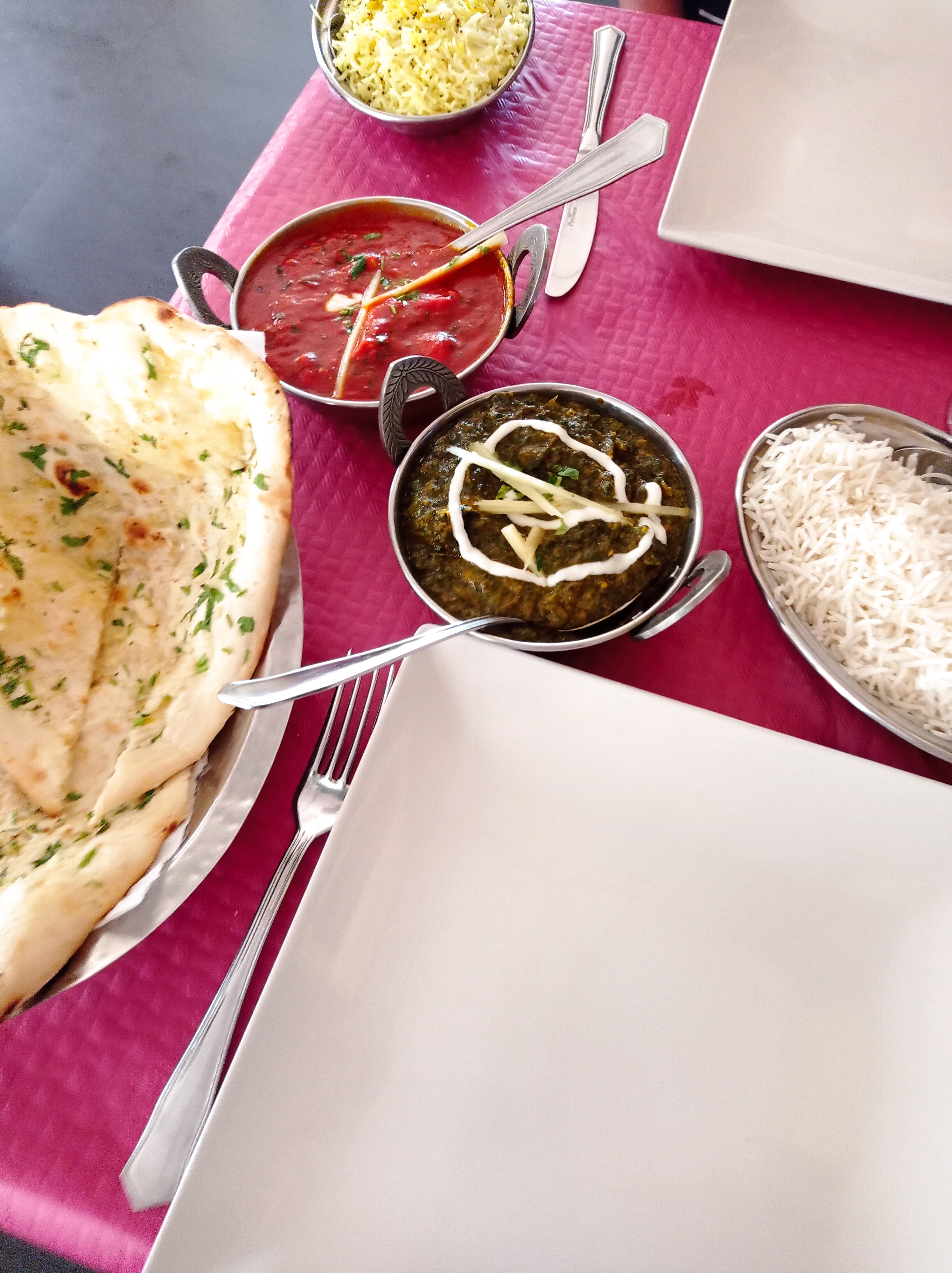 indian curries and rice on restaurant table
