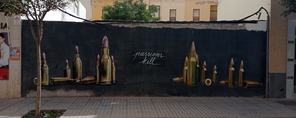 Mural of lipstick and pencils in bullet shapes with words Passions Kill