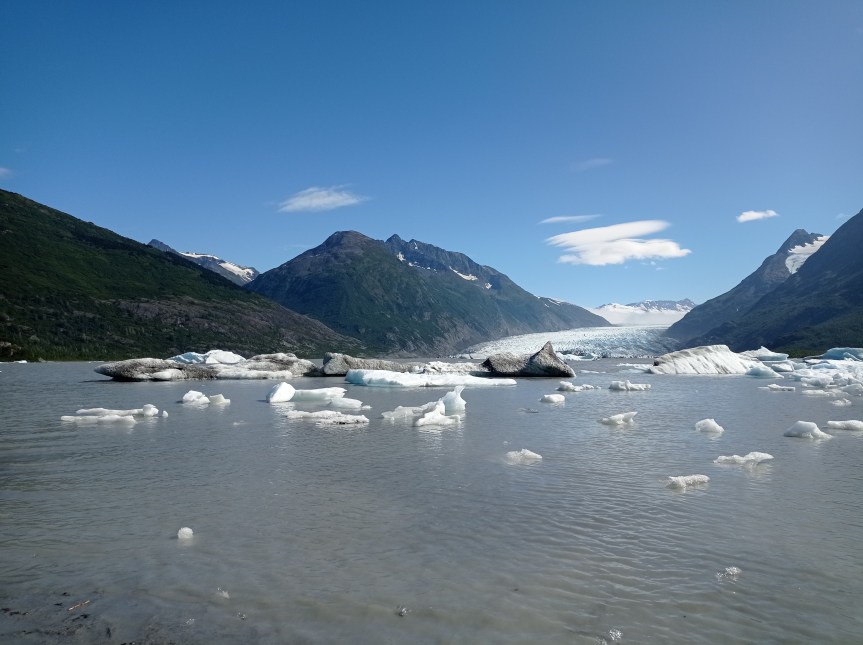 glacier with ice chunks floating in river