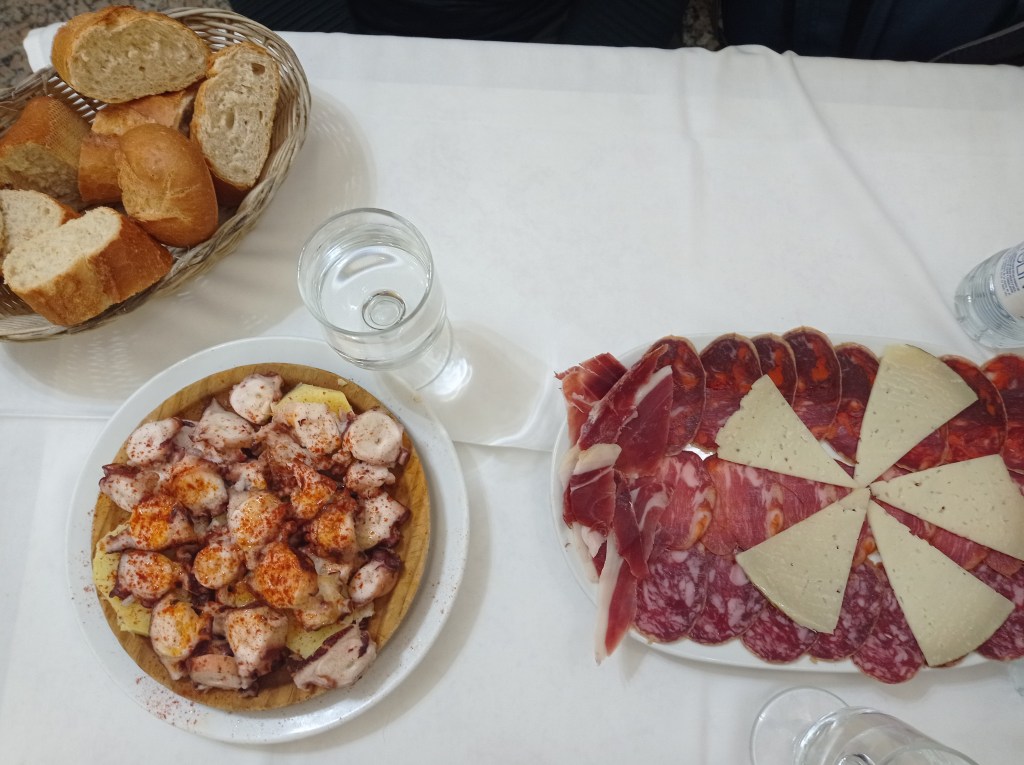 platters of octupus and tray with cured meat and cheese